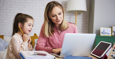 Homeoffice mit Kindern - Mutter und Kinder machen Homeoffice